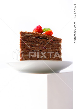 The piece of chocolate cake on white plate. A The piece of chocolate cake on white plate. A 67427321