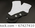 One pair of socks on a black background. 67427410
