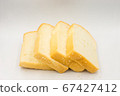 Four slices of bread arranged on a white background. 67427412