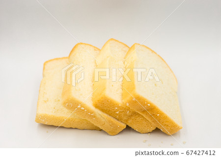 Four slices of bread arranged on a white background. Four slices of bread arranged on a white background. 67427412