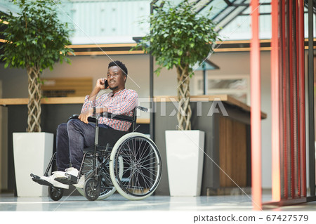 Disabled man talking on the phone Disabled man talking on the phone 67427579