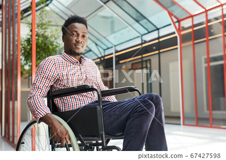 African man sitting in wheelchair African man sitting in wheelchair 67427598