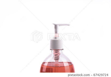 Red liquid soap in plastic pump bottle isolated on white background. 67429724