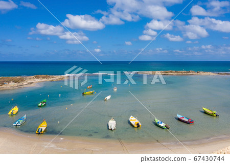 Small Fishing Boats anchored in a shallow lagoon, Aerial image. Small Fishing Boats anchored in a shallow lagoon, Aerial image. 67430744