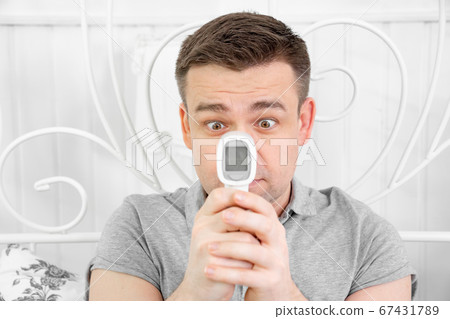 close up. male freelancer measures temperature. close up. male freelancer measures temperature. 67431789