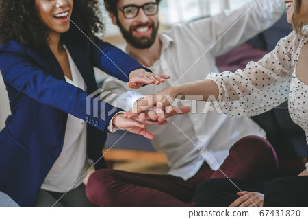 Three friends fellow enthusiasts showing their unity gesturing 67431820