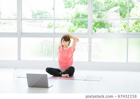 Young woman stretching online Young woman stretching online 67432158