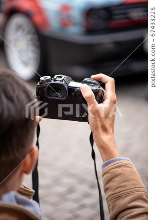 professional photographer takes pictures of a car 67433228