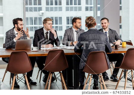 young caucasian men gathered to hold business meeting together young caucasian men gathered to hold business meeting together 67433852