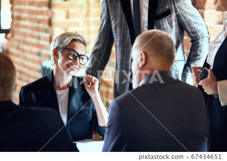 Business people at the negotiating table in the office Business people at the negotiating table in the office 67434651