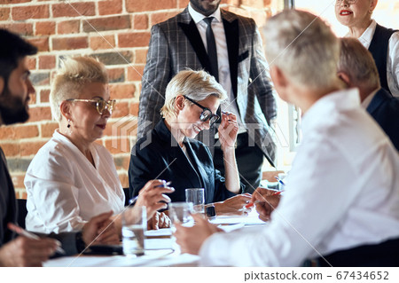 Business people at the negotiating table in the office Business people at the negotiating table in the office 67434652