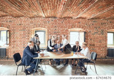 Group of business people brainstorming together in meeting room 67434670