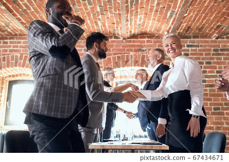 Group of business people brainstorming together in meeting room Group of business people brainstorming together in meeting room 67434671