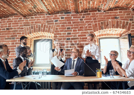 Group of business people brainstorming together in meeting room Group of business people brainstorming together in meeting room 67434683