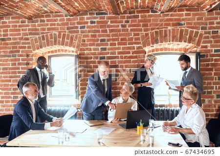 Group of business people brainstorming together in meeting room 67434695