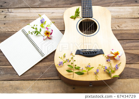 notebook planner and guitar of lifestyle woman relax summer and flowers frangipani ,purple flowers  67434729