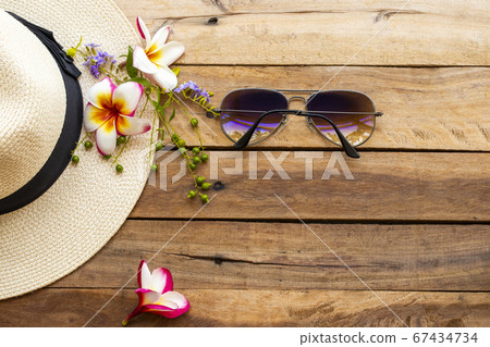 sunglasses and hat of lifestyle woman relax summer with purple flowers ,frangipani sunglasses and hat of lifestyle woman relax summer with purple flowers ,frangipani 67434734