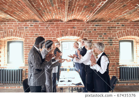 Group of business people brainstorming together in meeting room 67435376