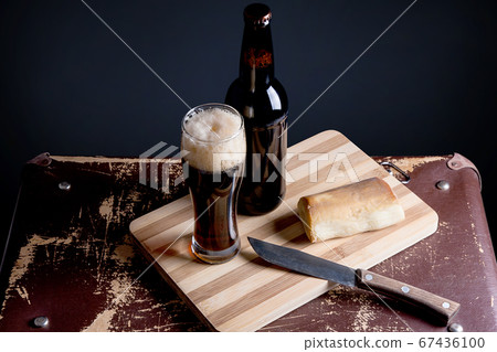 Glass and Bottle of dark beer with smoked cheese Glass and Bottle of dark beer with smoked cheese 67436100