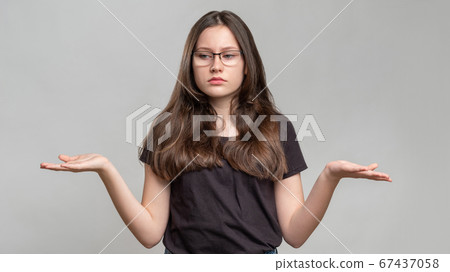 clueless woman portrait no idea overwhelmed shrug 67437058