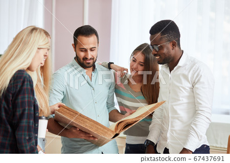 girl with glasses reads big book with blank cover in library girl with glasses reads big book with blank cover in library 67437691