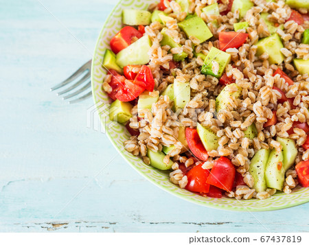 Fresh farro spelt salad with tomatoes, avocado Fresh farro spelt salad with tomatoes, avocado 67437819