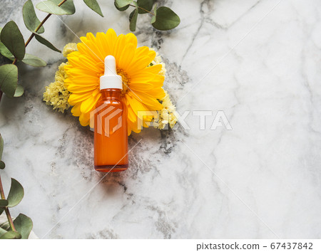 Vitamic C anti aging serum in orange bottle 67437842