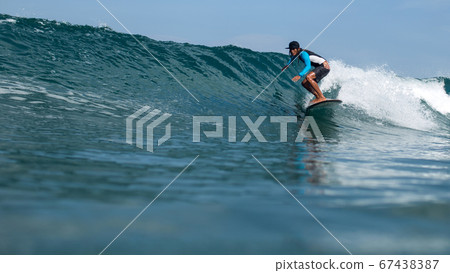 surfer riding a wave 67438387