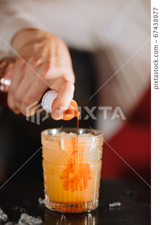 Exotic fruit cocktail in glass isolated on blurred restaurant background. Exotic fruit cocktail in glass isolated on blurred restaurant background. 67438977