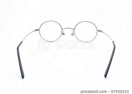 Inside of round-shaped silver-rimmed glasses White background 67439233