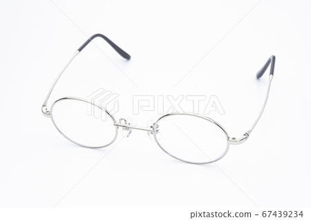 Round silver-rimmed glasses on white background 67439234
