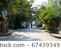 Road in old city of Luang Prabang, where motorbikes run 67439349