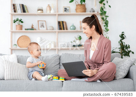 Work From Home With Baby. Mom Using Laptop And Playing With Son Work From Home With Baby. Mom Using Laptop And Playing With Son 67439583