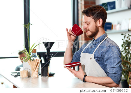 Confident self assured barista at bar counter Confident self assured barista at bar counter 67439632