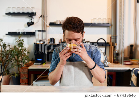 Confident self assured barista at bar counter Confident self assured barista at bar counter 67439640