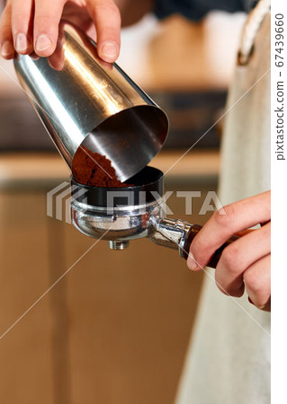 hand of barista making latte or cappuccino coffee hand of barista making latte or cappuccino coffee 67439660