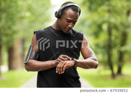 African man working out with fitness bracelet 67439852