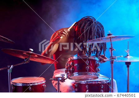 portrait of professional drummer man isolated in smoky space portrait of professional drummer man isolated in smoky space 67440501