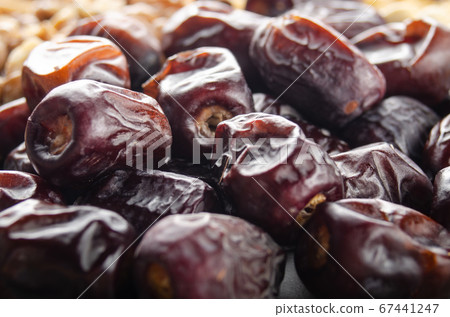 Pile of dried dates fruits on kitchen table. 67441247