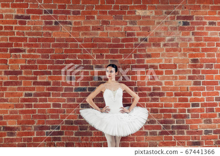 thoughtful serious dancer in fashion outfit standing over the loft wall thoughtful serious dancer in fashion outfit standing over the loft wall 67441366