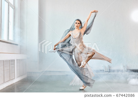 Female ballet dancer with white flowing fabric. Flow shapes and movement. 67442086