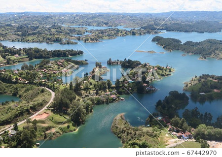 A superb view overlooking the lake surrounded by green hills A superb view overlooking the lake surrounded by green hills 67442970