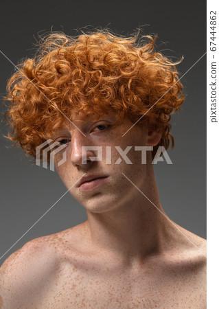 Portrait of beautiful redhead man isolated on grey studio background. Concept of beauty, skin care, fashion and style Portrait of beautiful redhead man isolated on grey studio background. Concept of beauty, skin care, fashion and style 67444862