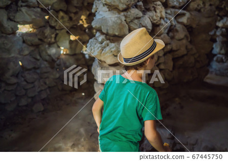 Boy tourist in Chua Tu Van temple made of shells and corals or the dragon maze. Travel to Vietnam Concept. Traveling with children concept 67445750