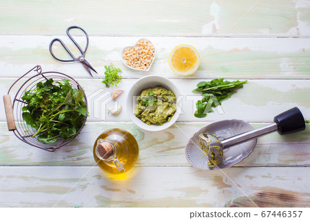Wild herbs pesto ingresitnts on white wooden background Wild herbs pesto ingresitnts on white wooden background 67446357