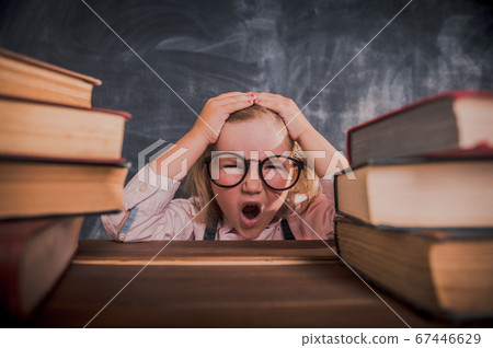 Little businessman under stress missing her deadlines. Back to school. Little kid with stack of books doing homework. Instagram filters 67446629