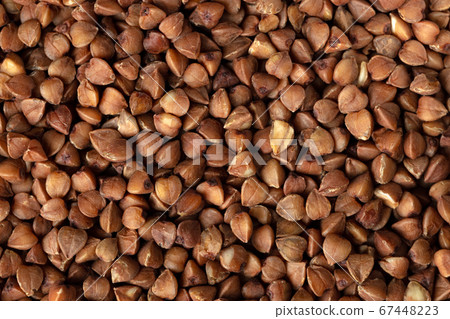 Dry uncooked buckwheat grain background, close up 67448223