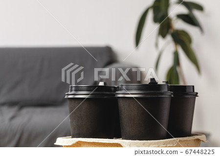 Black take away coffee cups in holder 67448225