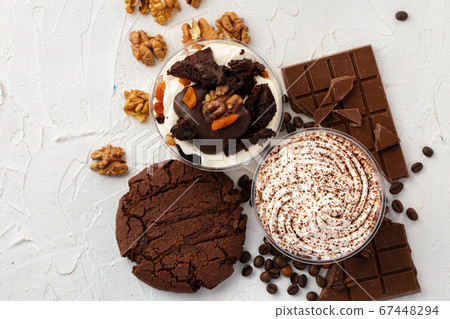 Cocoa mousse dessert in plastic transparent box on grey surface Cocoa mousse dessert in plastic transparent box on grey surface 67448294