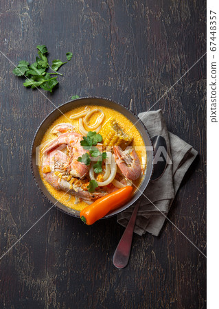 Peruvian seafood soup Chupe de Camarones in gray bowl, top view Peruvian seafood soup Chupe de Camarones in gray bowl, top view 67448357